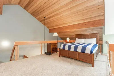 a bedroom with a bed and a wooden ceiling at Snowcreek IV 588 in Mammoth Lakes