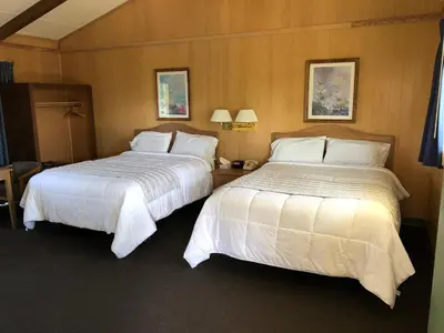 two beds sitting next to each other in a hotel room at Meadowcliff Lodge Coleville in Coleville