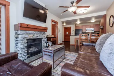 a living room with a couch and a fireplace at Village 3211 in Mammoth Lakes