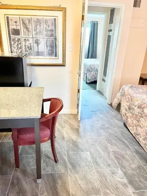 a living room with a table and a couch at Royal Lodge in Coalinga