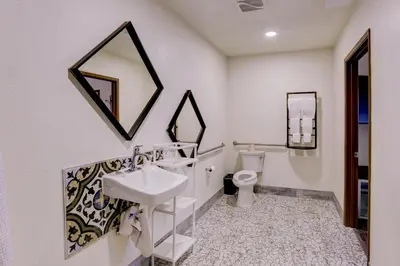 a bathroom with a sink and a toilet at The Greens Hotel on Stockton in Sacramento