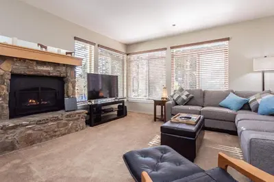 a living room with a couch and a fireplace at Silver Bear #19 Condo in Mammoth Lakes