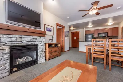 a living room with a fireplace and a dining room at Village # 3310 - Lincoln House in Mammoth Lakes