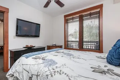 a bedroom with a bed and a flat screen tv at Village # 3310 - Lincoln House in Mammoth Lakes