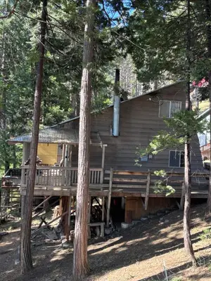 a log cabin in the woods with trees at Sequoia National Forest CabinK in Panorama Heights