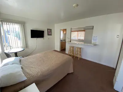 a bedroom with a bed and a television in it at Bristlecone Motel in Big Pine