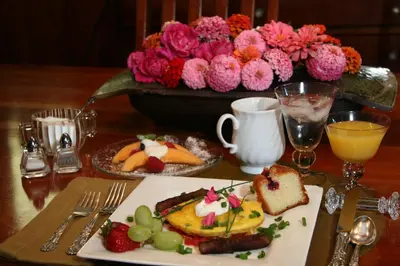 a table with a plate of food on a table at Eureka Street Inn in Sutter Creek