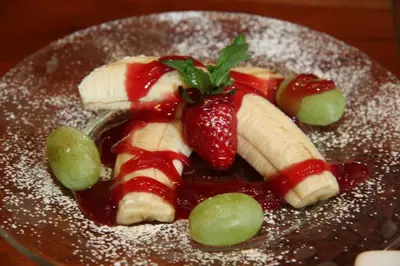 a plate of fruit with bananas strawberries and grapes at Eureka Street Inn in Sutter Creek