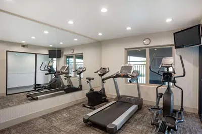 a gym with treadmills and elliptical machines at Best Western Exeter Inn & Suites in Exeter