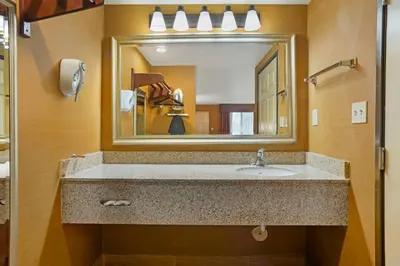 a bathroom with a sink and a large mirror at Best Western Exeter Inn & Suites in Exeter