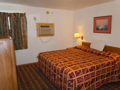 a hotel room with a bed and a window at Value Inn in Fallon