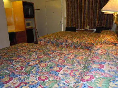 a hotel room with two beds with a colorful bedspread at Value Inn in Fallon