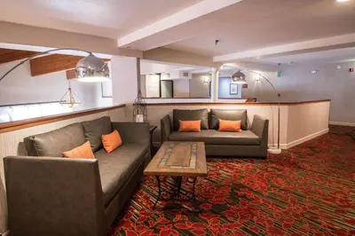 a living room with two couches and a table at Empeiria High Sierra Hotel in Mammoth Lakes