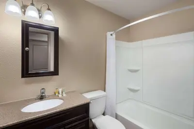 a bathroom with a sink and a toilet and a shower at Super 8 by Wyndham Fallon in Fallon