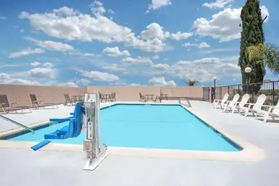 a swimming pool with a slide in the middle at Days Inn by Wyndham Lost Hills in Lost Hills