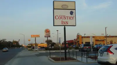 a county inn sign on the side of a street at Corcoran Country Inn in Corcoran