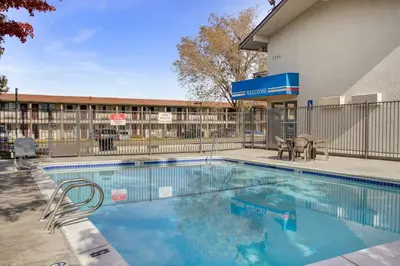 a swimming pool in front of a building at Motel 6-Carson City, NV in Carson City