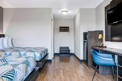 a hotel room with a bed and a desk at Motel 6-Carson City, NV in Carson City