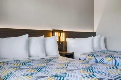 two beds with white pillows in a hotel room at Motel 6-Carson City, NV in Carson City