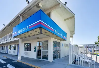 a building with a blue sign on the front of it at Motel 6-Carson City, NV in Carson City