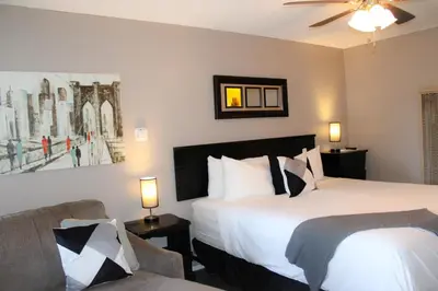a hotel room with two beds and a couch at The Alder Inn in South Lake Tahoe