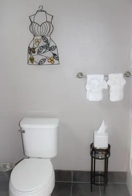 a bathroom with a toilet and two rolls of toilet paper at The Alder Inn in South Lake Tahoe