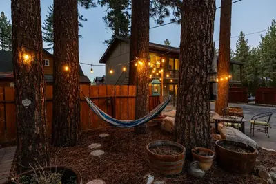 a hammock in the trees in front of a house at The Alder Inn in South Lake Tahoe