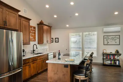 a kitchen with a stainless steel refrigerator and wooden cabinets at 11R Spring Meadow Retreat in Wawona
