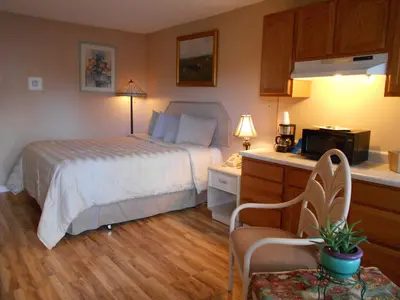 a hotel room with a bed and a microwave at Victorian Inn in Reno
