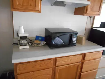 a microwave sitting on top of a kitchen counter at Victorian Inn in Reno