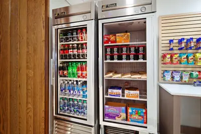 a refrigerator filled with lots of soda and drinks at Holiday Inn Express & Suites Clovis Fresno Area by IHG in Clovis