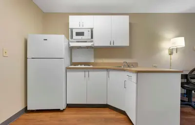 a kitchen with white cabinets and a white refrigerator at Extended Stay America Suites - Stockton - March Lane in Stockton