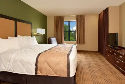 a hotel room with a bed and a television at Extended Stay America Suites - Stockton - March Lane in Stockton