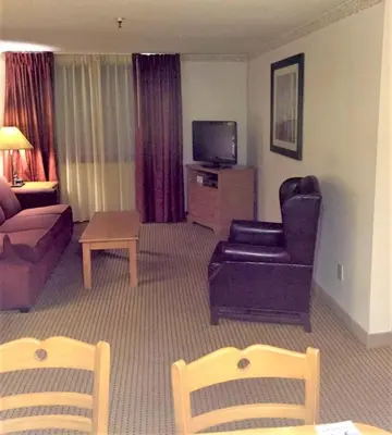 a living room with a couch and a tv at Heidelberg Inn & Resort in June Lake