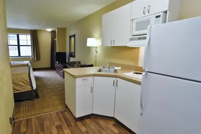 a kitchen with a white refrigerator and a room at Extended Stay America Suites - Stockton - Tracy in Tracy