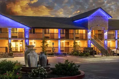 a building with blue lights in front of it at Days Inn by Wyndham Galt - Elk Grove South in Galt