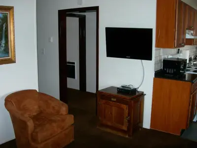 a living room with a chair and a television at Walker River Lodge in Bridgeport