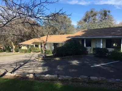 a house with a driveway in front of it at Lazy J Ranch Motel in Three Rivers