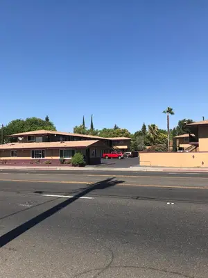 an empty street in front of a building at Economy Inn in Modesto