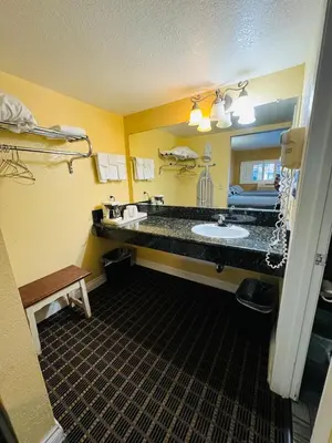 a hotel bathroom with a sink and a mirror at Mount Whitney Motel in Lone Pine