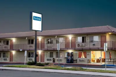 a building with a sign in front of it at Baymont by Wyndham Coalinga in Coalinga