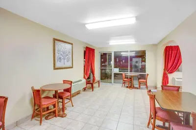 a waiting room with tables and chairs at Baymont by Wyndham Coalinga in Coalinga