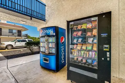 a soda vending machine sitting next to a building at Econo Lodge Stockton near I-5 Fairgrounds in Stockton