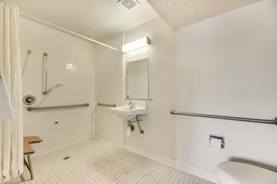 a white bathroom with a sink and a toilet at Econo Lodge Stockton near I-5 Fairgrounds in Stockton