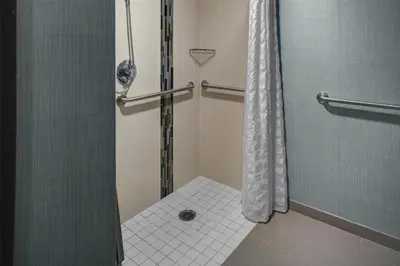 a bathroom with a shower with a shower curtain at Hyatt Place Sacramento Rancho Cordova in Rancho Cordova