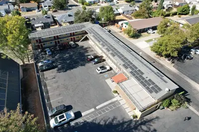 an overhead view of a building with solar panels on the roof at Sky Riders Motel in Sacramento