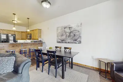 a living room with a table and chairs and a kitchen at Dolomite Delight in Truckee