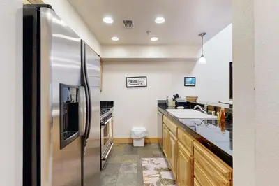 a large kitchen with a stainless steel refrigerator at Tavern Inn #55 in Olympic Valley