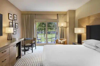 a hotel room with a bed and a desk and a window at Hyatt Regency Lake Tahoe Resort, Spa & Casino in Incline Village