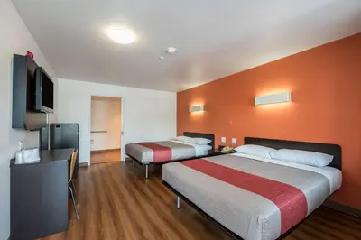 a hotel room with two beds and a flat screen tv at Motel 6-Fallon, NV in Fallon